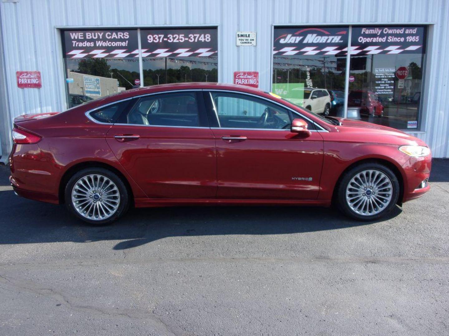 2014 RED FORD FUSION TITANIUM HYBRID (3FA6P0RU3ER) with an 2.0L engine, Continuously Variable transmission, located at 501 E. Columbia St., Springfield, OH, 45503, (800) 262-7122, 39.925262, -83.801796 - ***1-Owner***TITANIUM HYBRID***New Tires***Heated Leather Seating***Back-up Camera***Serviced and Detailed*** Jay North Auto has offered hand picked vehicles since 1965! Our customer's enjoy a NO pressure buying experience with a small town feel. All of our vehicles get fully inspected and detai - Photo#0