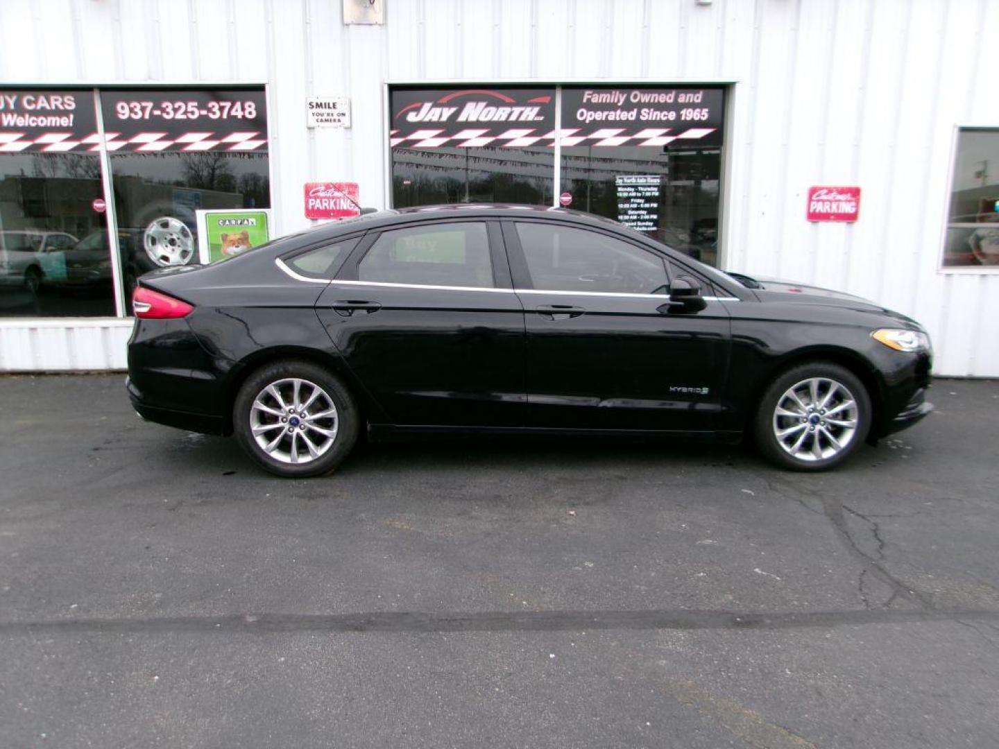 2017 BLACK FORD FUSION SE HYBRID (3FA6P0LU1HR) with an 2.0L engine, Continuously Variable transmission, located at 501 E. Columbia St., Springfield, OH, 45503, (800) 262-7122, 39.925262, -83.801796 - ***Hybrid***SE***New Brakes***Back-up Camera***SYNC 3***Serviced and Detailed*** Jay North Auto has offered hand picked vehicles since 1965! Our customer's enjoy a NO pressure buying experience with a small town feel. All of our vehicles get fully inspected and detailed. We are a preferred dea - Photo#0