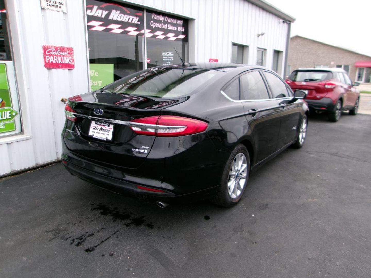2017 BLACK FORD FUSION SE HYBRID (3FA6P0LU1HR) with an 2.0L engine, Continuously Variable transmission, located at 501 E. Columbia St., Springfield, OH, 45503, (800) 262-7122, 39.925262, -83.801796 - ***Hybrid***SE***New Brakes***Back-up Camera***SYNC 3***Serviced and Detailed*** Jay North Auto has offered hand picked vehicles since 1965! Our customer's enjoy a NO pressure buying experience with a small town feel. All of our vehicles get fully inspected and detailed. We are a preferred dea - Photo#3