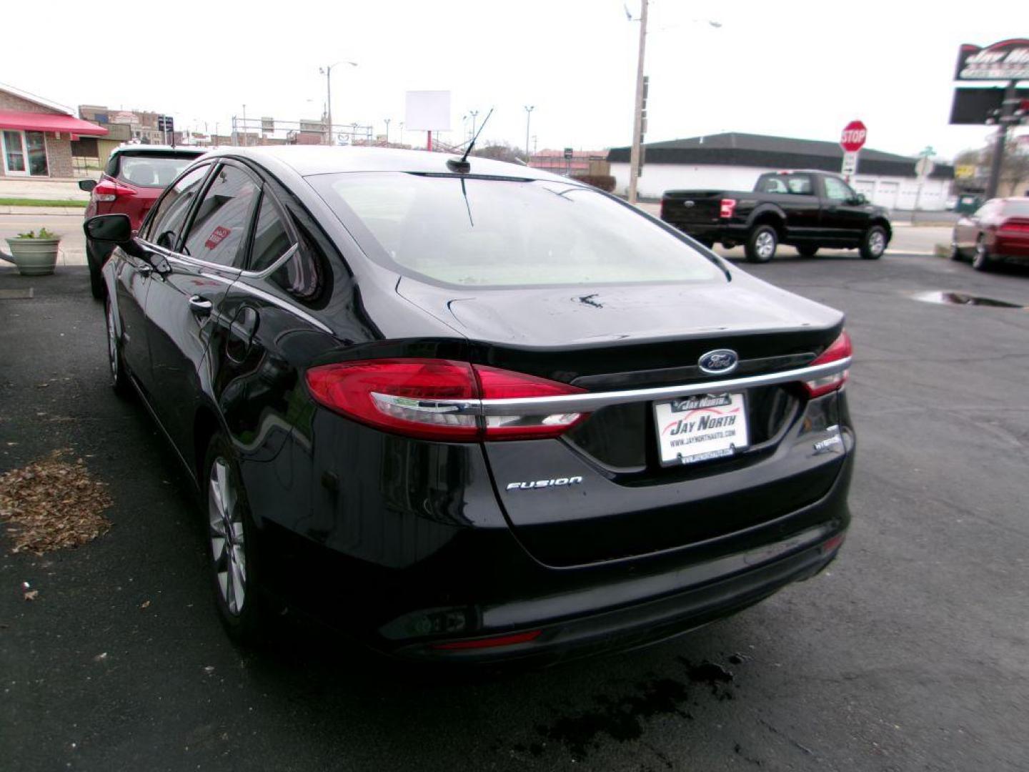 2017 BLACK FORD FUSION SE HYBRID (3FA6P0LU1HR) with an 2.0L engine, Continuously Variable transmission, located at 501 E. Columbia St., Springfield, OH, 45503, (800) 262-7122, 39.925262, -83.801796 - ***Hybrid***SE***New Brakes***Back-up Camera***SYNC 3***Serviced and Detailed*** Jay North Auto has offered hand picked vehicles since 1965! Our customer's enjoy a NO pressure buying experience with a small town feel. All of our vehicles get fully inspected and detailed. We are a preferred dea - Photo#5