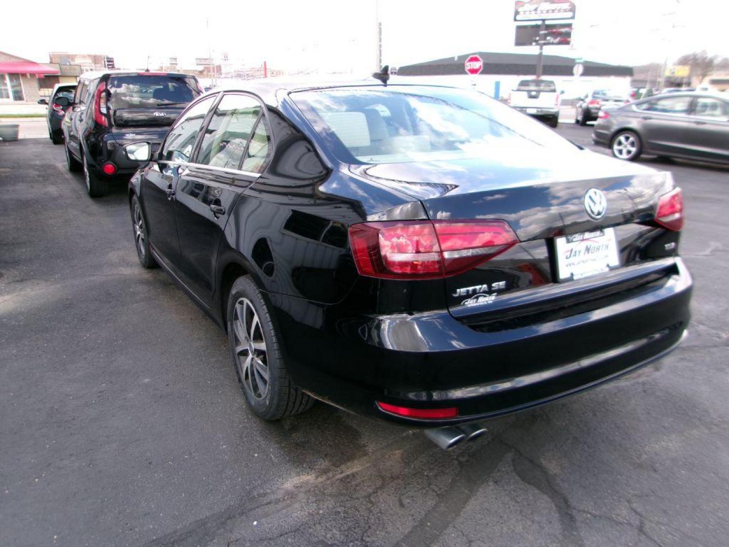 2017 BLACK VOLKSWAGEN JETTA SE (3VWDB7AJ8HM) with an 1.4L engine, Automatic transmission, located at 501 E. Columbia St., Springfield, OH, 45503, (800) 262-7122, 39.925262, -83.801796 - *** New Tires *** Serviced and Detailed *** New Brakes *** SE *** Moonroof *** Leather *** Jay North Auto has offered hand picked vehicles since 1965! Our customer's enjoy a NO pressure buying experience with a small town feel. All of our vehicles get fully inspected and detailed. We are a pref - Photo#5