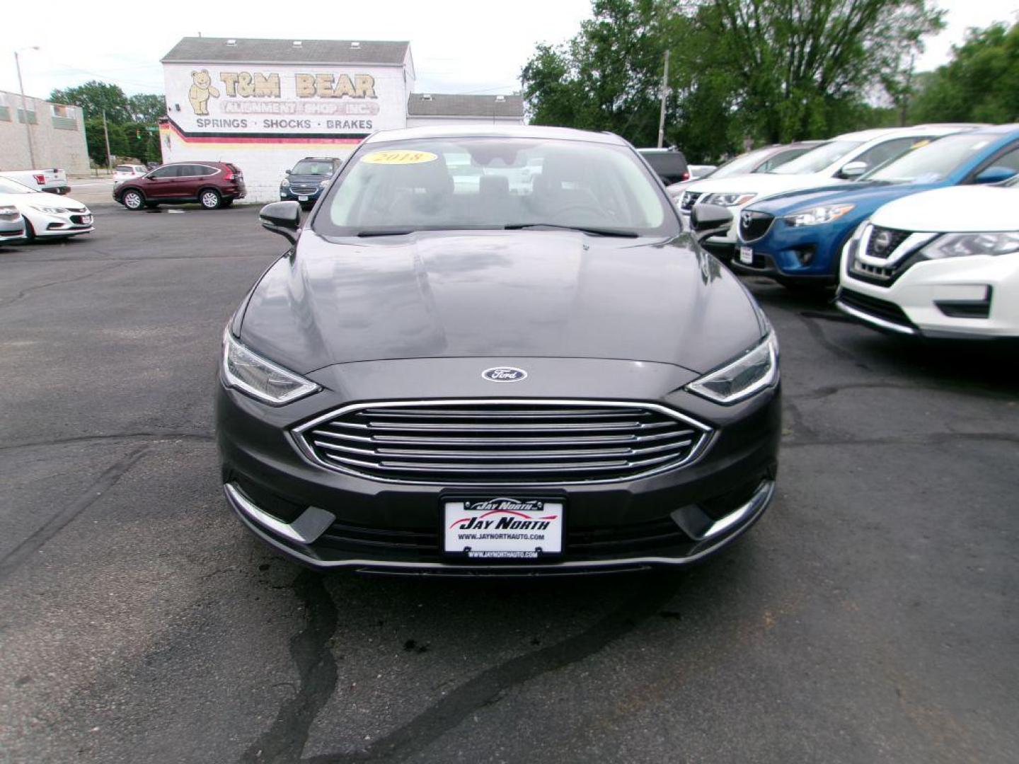 2018 GRAY FORD FUSION SE HYBRID (3FA6P0LU5JR) with an 2.0L engine, Continuously Variable transmission, located at 501 E. Columbia St., Springfield, OH, 45503, (800) 262-7122, 39.925262, -83.801796 - *** Leather *** Back Up Camera *** SE Hybrid *** Serviced and Detailed *** Clean CarFax with 21 Service Records *** Alloy Wheels *** Jay North Auto has offered hand picked vehicles since 1965! Our customer's enjoy a NO pressure buying experience with a small town feel. All of our vehicles get f - Photo#1