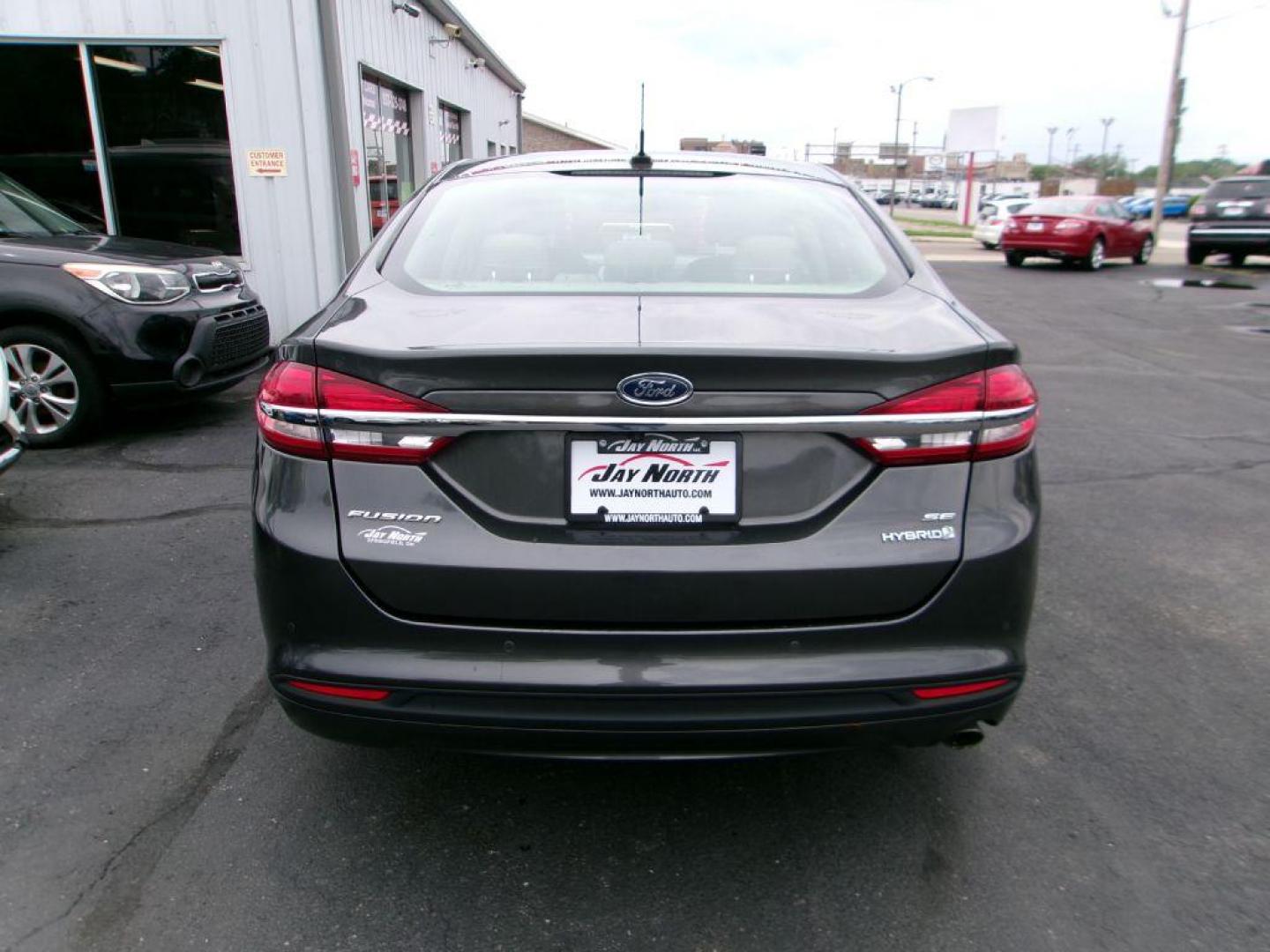 2018 GRAY FORD FUSION SE HYBRID (3FA6P0LU5JR) with an 2.0L engine, Continuously Variable transmission, located at 501 E. Columbia St., Springfield, OH, 45503, (800) 262-7122, 39.925262, -83.801796 - *** Leather *** Back Up Camera *** SE Hybrid *** Serviced and Detailed *** Clean CarFax with 21 Service Records *** Alloy Wheels *** Jay North Auto has offered hand picked vehicles since 1965! Our customer's enjoy a NO pressure buying experience with a small town feel. All of our vehicles get f - Photo#5