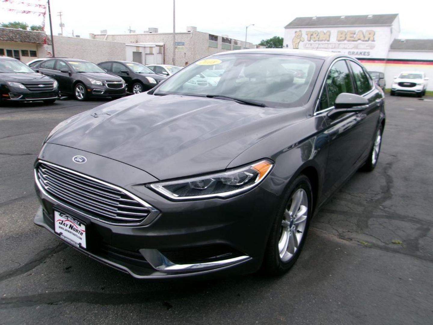 2018 GRAY FORD FUSION SE HYBRID (3FA6P0LU5JR) with an 2.0L engine, Continuously Variable transmission, located at 501 E. Columbia St., Springfield, OH, 45503, (800) 262-7122, 39.925262, -83.801796 - *** Leather *** Back Up Camera *** SE Hybrid *** Serviced and Detailed *** Clean CarFax with 21 Service Records *** Alloy Wheels *** Jay North Auto has offered hand picked vehicles since 1965! Our customer's enjoy a NO pressure buying experience with a small town feel. All of our vehicles get f - Photo#7