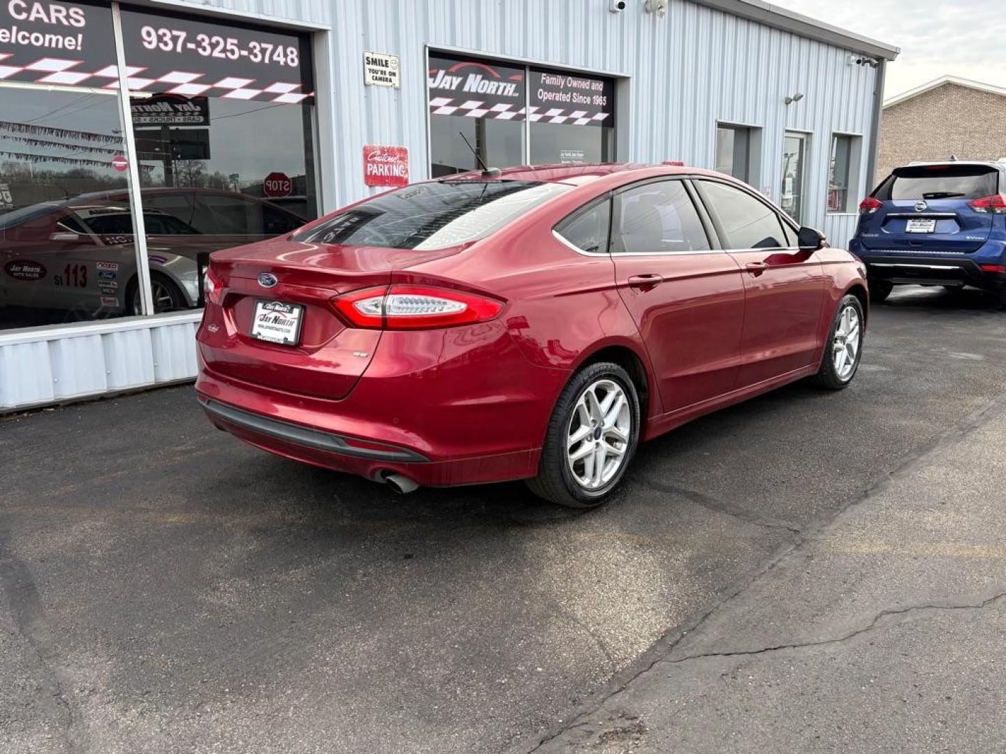 2014 RED FORD FUSION SE (3FA6P0H73ER) with an 2.5L engine, Automatic transmission, located at 501 E. Columbia St., Springfield, OH, 45503, (800) 262-7122, 39.925262, -83.801796 - ***Clean Carfax***New Tires***New Front and Rear Brakes***New Air Filter and Cabin Air Filter***New Spark Plugs***Fresh Oil Change***Detailed and Ready To Go*** Jay North Auto has offered hand picked vehicles since 1965! Our customer's enjoy a NO pressure buying experience with a small town fe - Photo#2